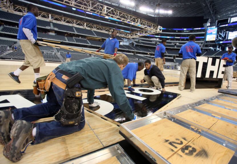 Work crews built a basketball court at Cowboys Stadium on Monday ahead of the South Regional...