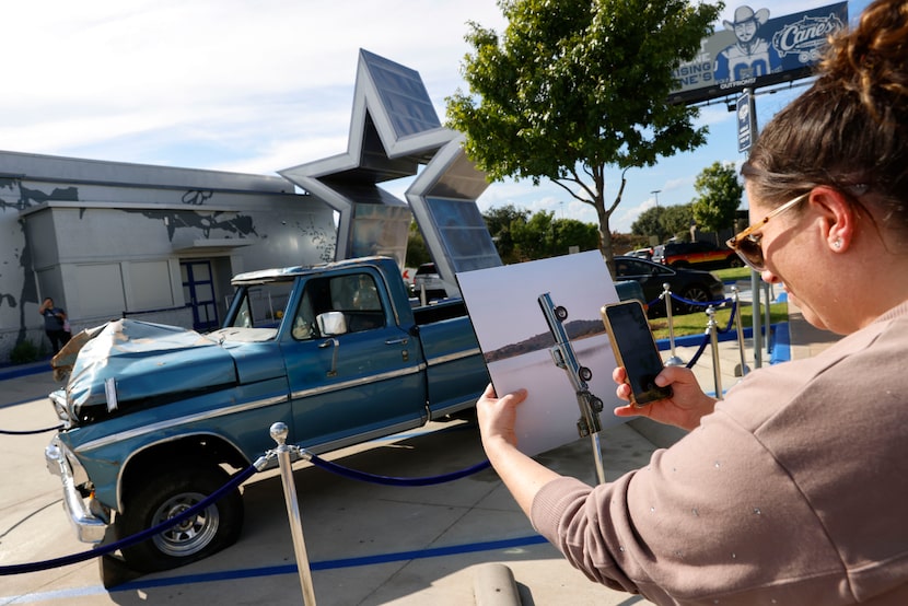 Jennifer Selenke of Waxahachie takes a photo of the new Post Malone album, "F-1 Trillion,"...