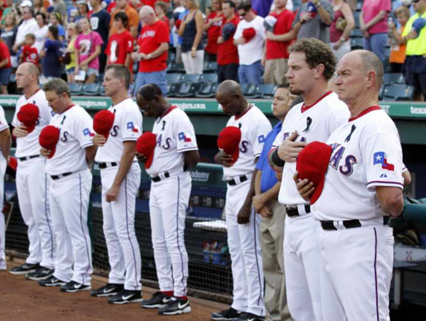 Josh Hamilton (second from right) and Rangers teammates and fans observed a moment of...