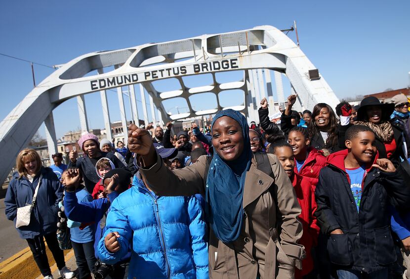 School kids walk across the Edmund Pettus Bridge as they visit historic sites from the Selma...