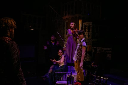 Ian Ferguson (as Pierre Bezukhov, left) and other cast members perform in a scene from...