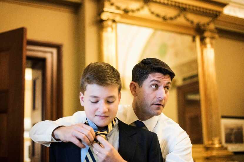 While meeting with staff, Speaker of the House Paul Ryan, R-Wis., ties a tie for his...