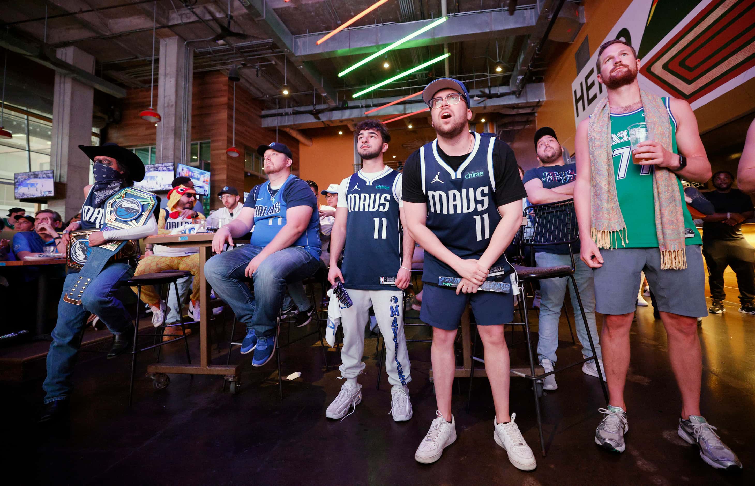 Dallas Mavericks fans including Matthew Singer of Dallas, second from right, react during a...