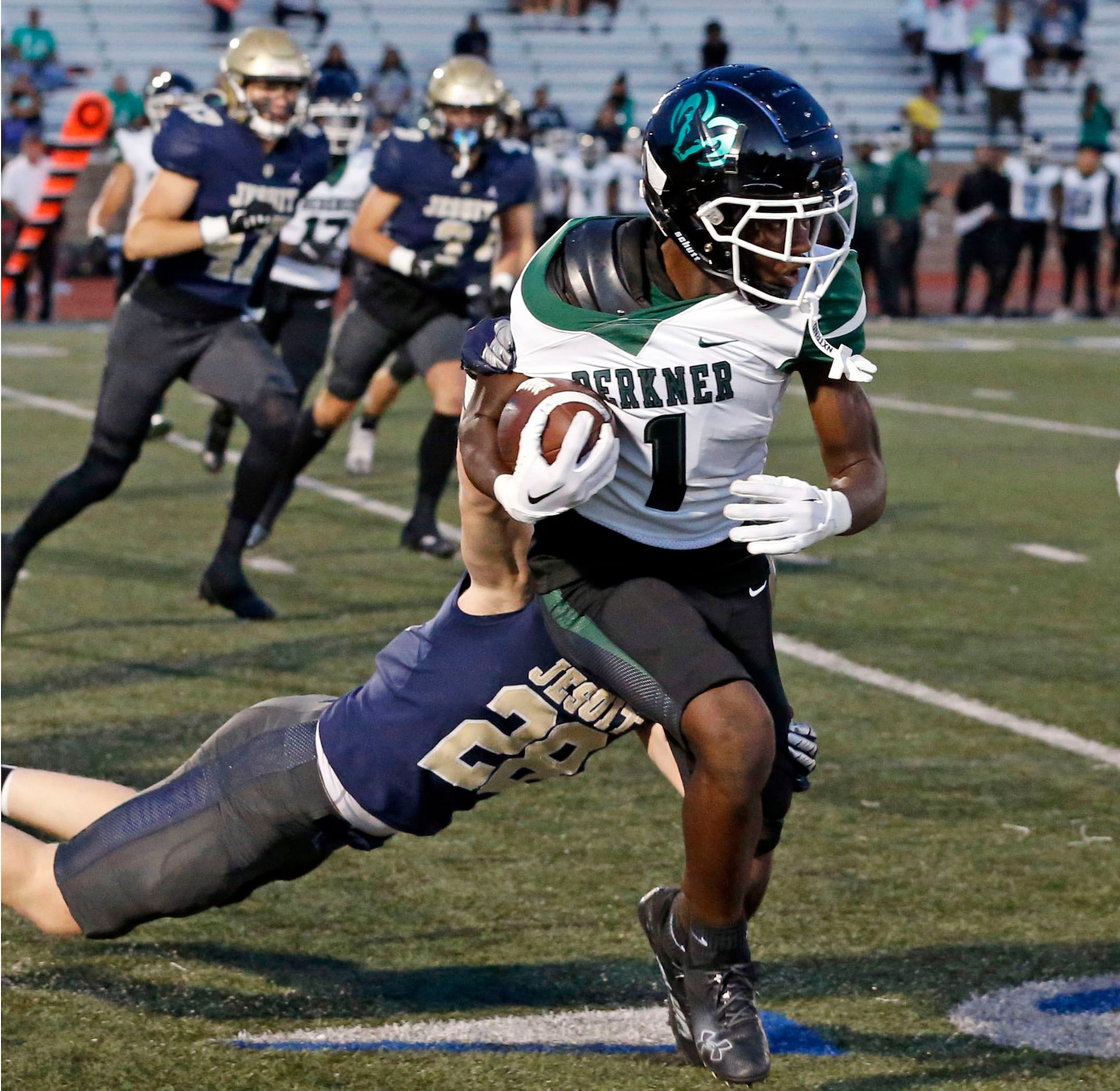 Richardson Berkner returner Laween Ahmed  (1) has his jersey pulled back by Jesuit defender...