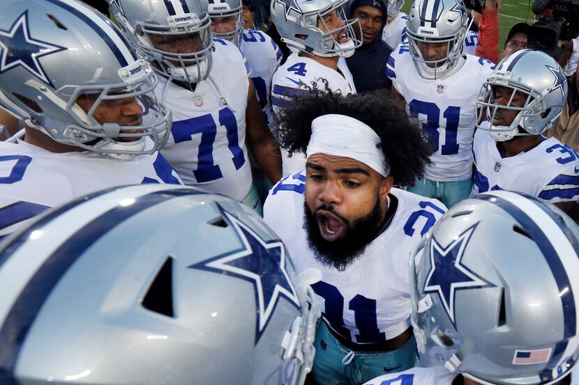 Dallas Cowboys players get fired up by running back Ezekiel Elliott (21) before their NFC...