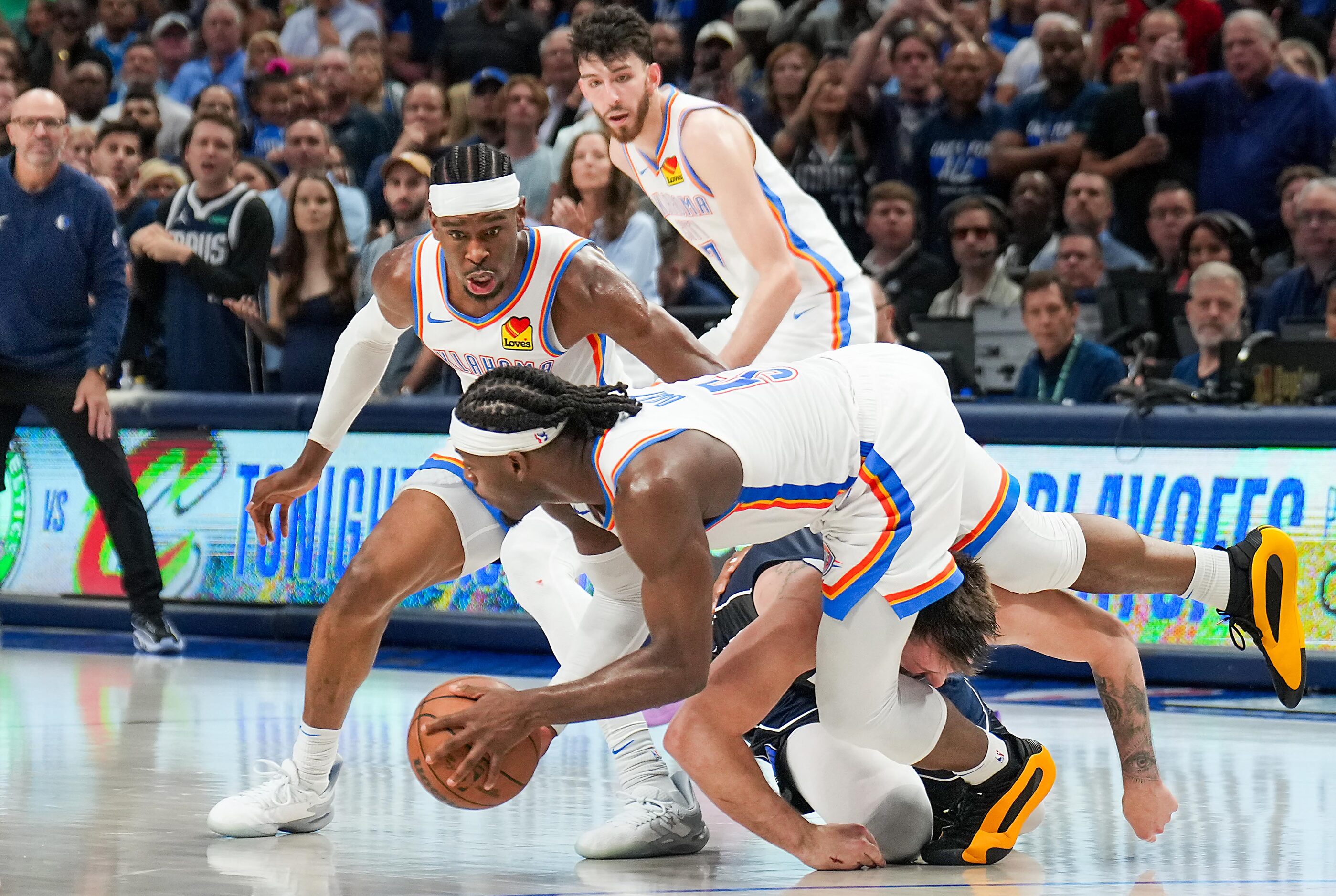 Oklahoma City Thunder guard Luguentz Dort (5) scoops up the ball as Dallas Mavericks guard...