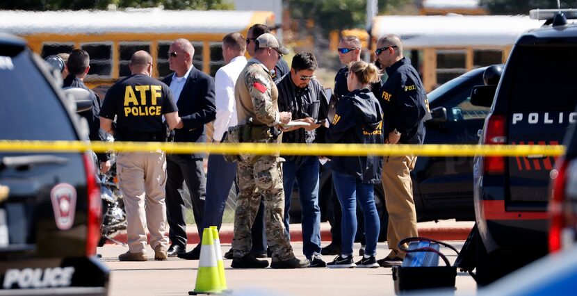 Police officials work the scene of a school shooting at Mansfield Timberview High School in...