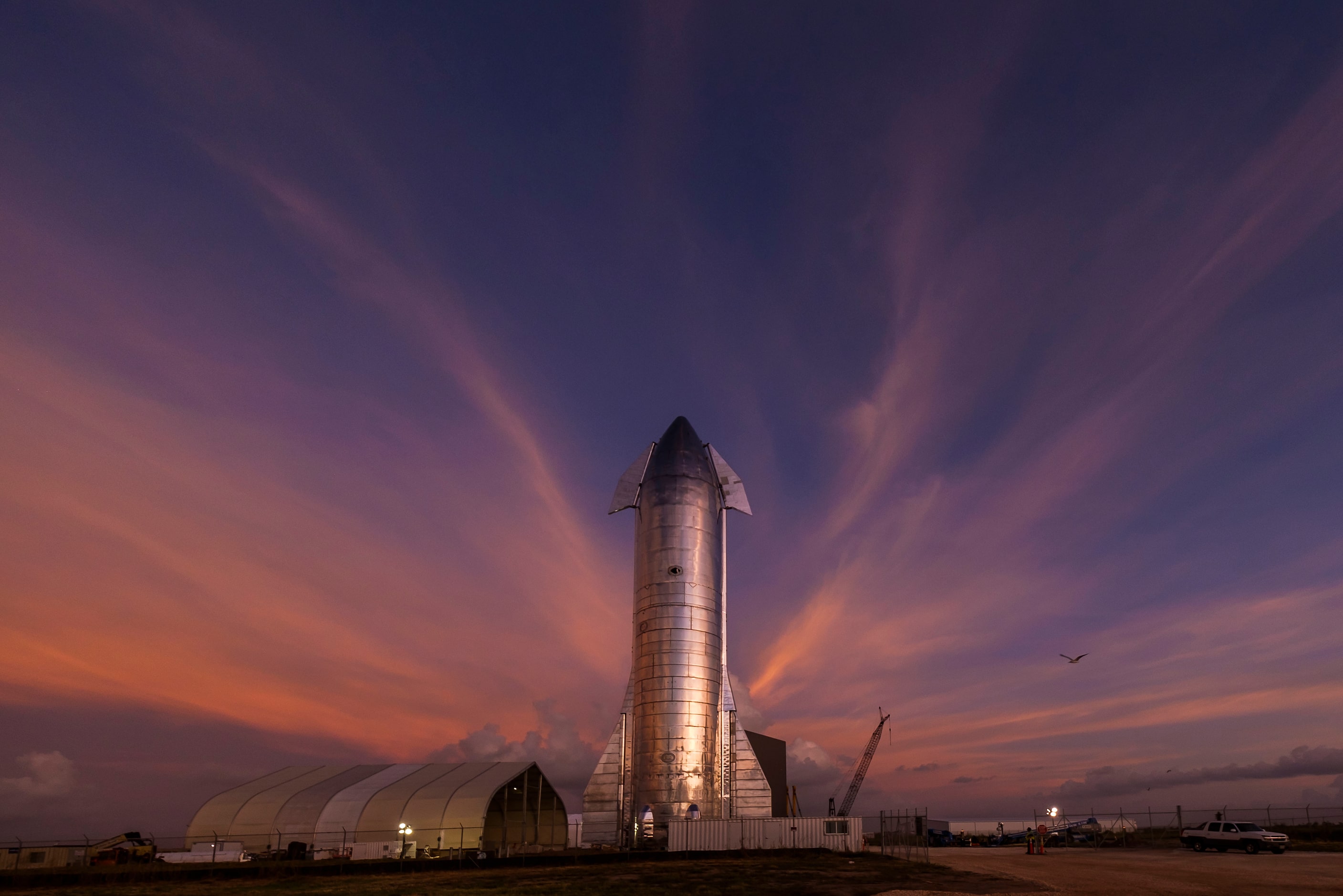 The sky begins to light up before sunrise over a prototype of the SpaceX Starship at the...