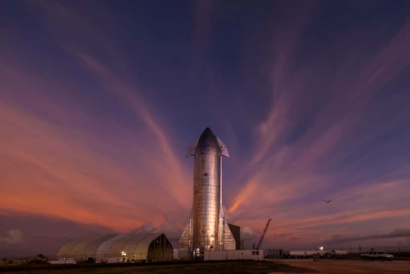 The sky begins to light up before sunrise over a prototype of the SpaceX Starship at the...