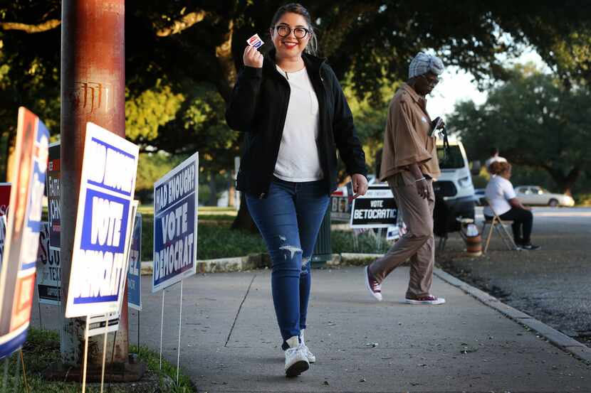 Maria Garcia, a first-time voter, leaves the polling station holding her "I Voted Today!"...