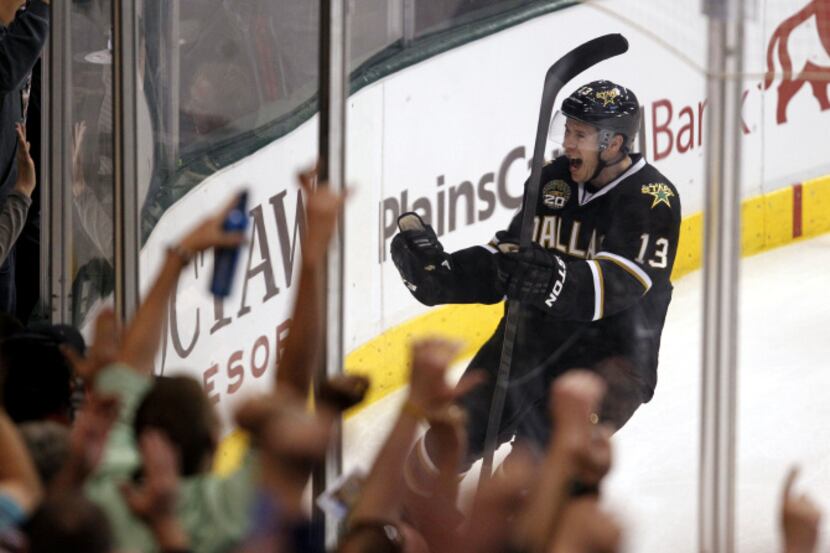Dallas Stars left wing Ray Whitney (13) celebrates with fans after scoring a goal on Los...