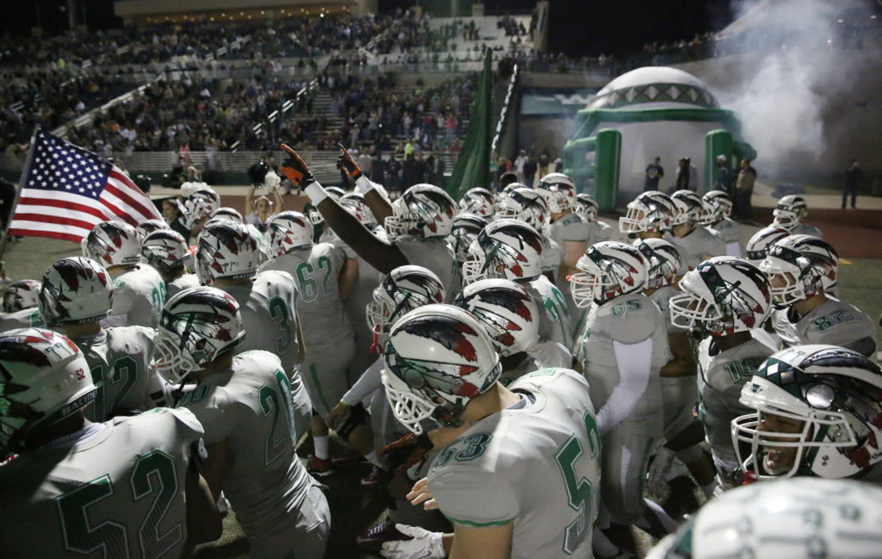 Waxahachie players enter the field before a high school football game between Lancaster and...