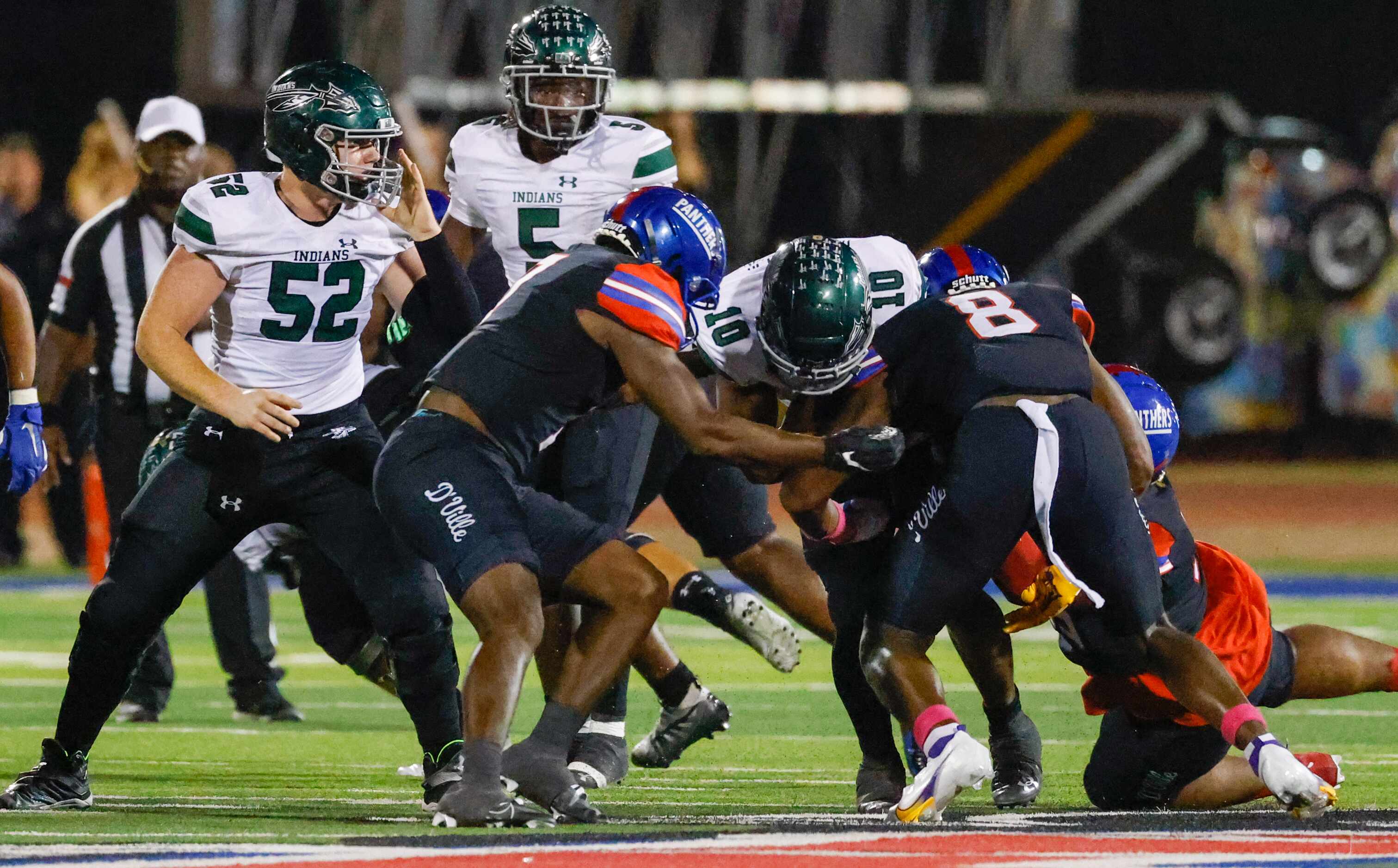 Duncanville line backer Colin Simmons (8) assists in tackling Waxahachie quarterback...