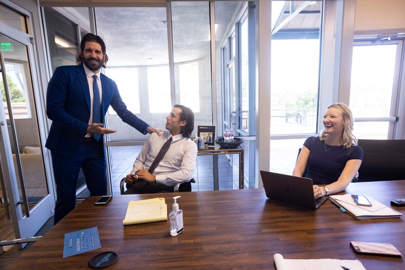 From left: Owner and CEO Rogers Healy steps into a meeting to say hi to client relationship...