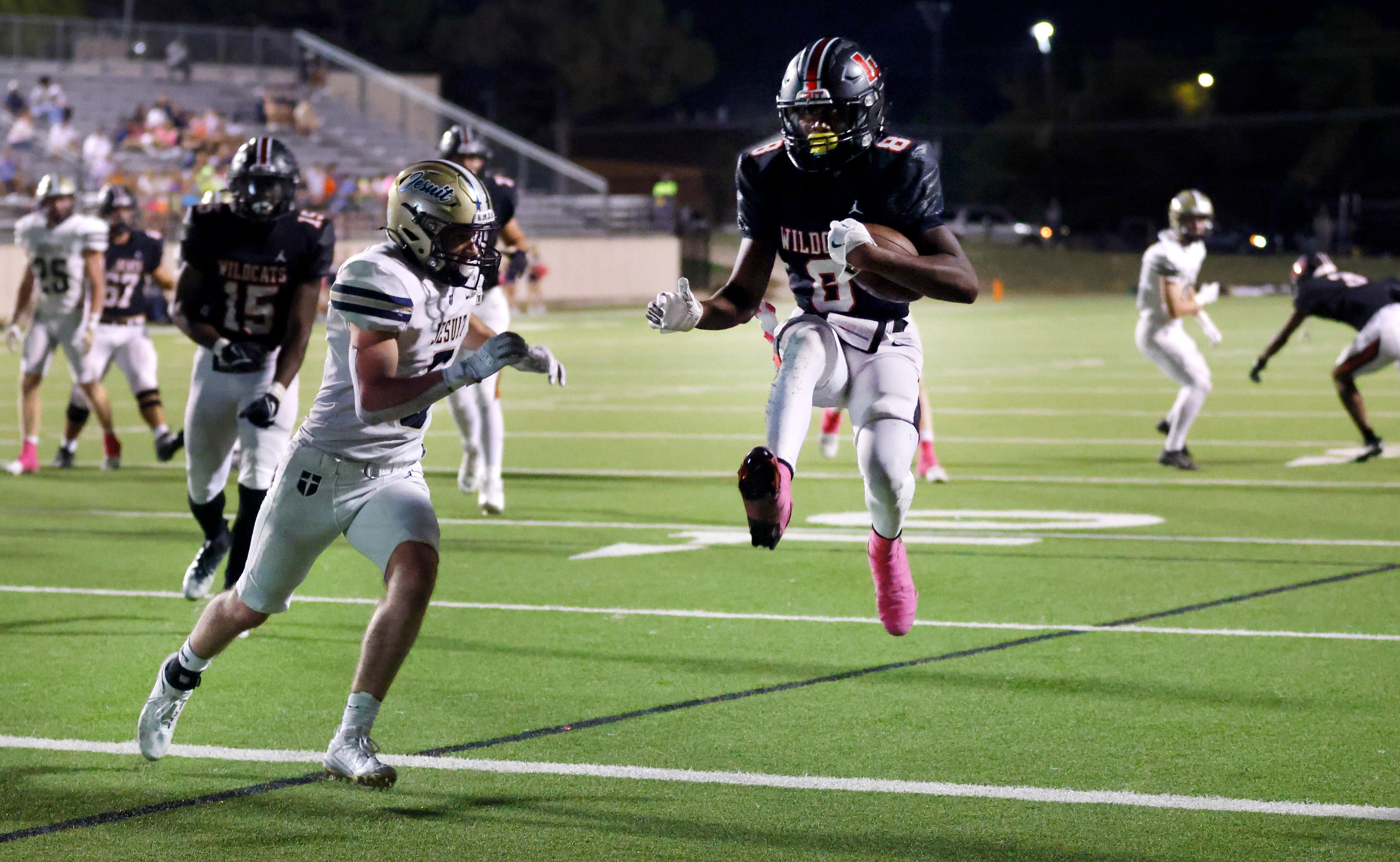 Lake Highlands High running back Mo Kamara (8) leaps over the goal line scoring a first half...