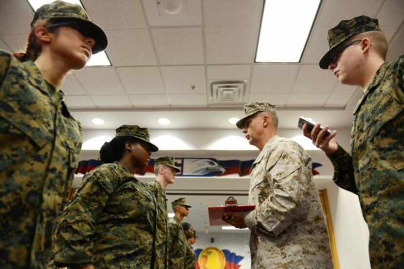 
Maj. Tom Connor, lead instructor for Allen High School’s Junior ROTC program, performs a...
