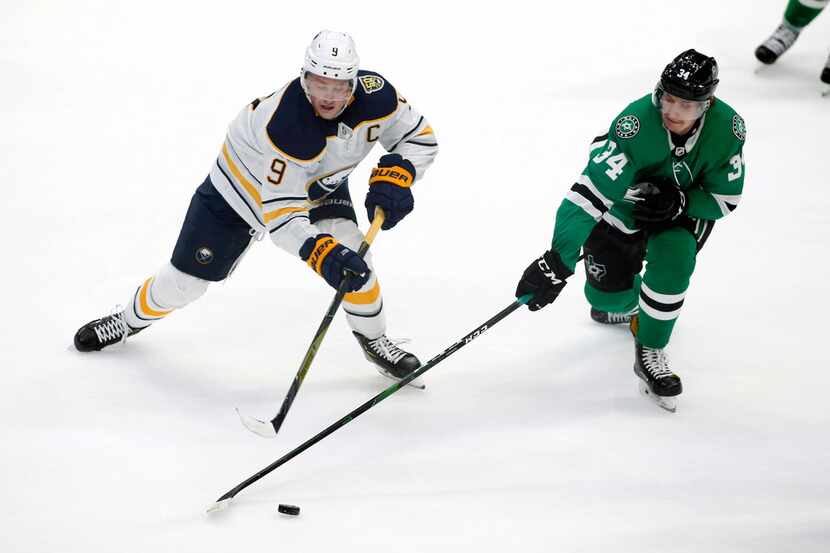 Buffalo Sabres center Jack Eichel, left, and Dallas Stars right wing Denis Gurianov, right,...
