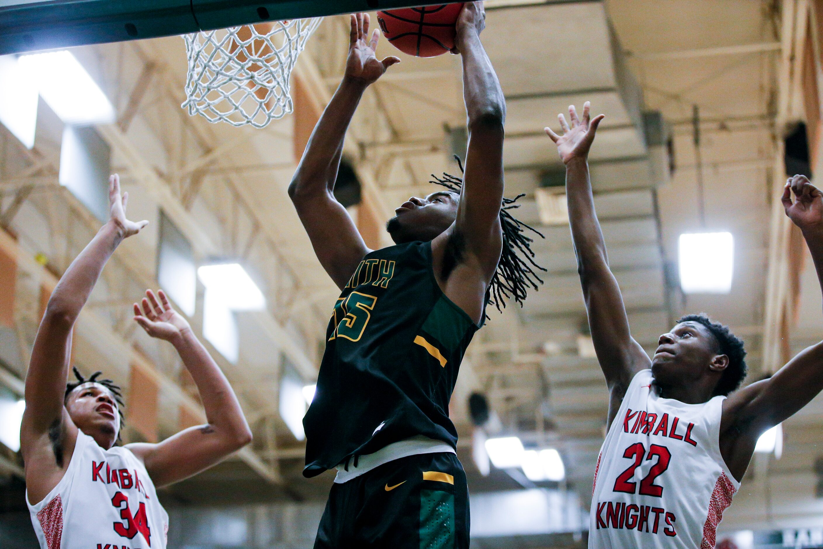 Newman Smith senior Domani Villaruel (25) attempts a layup as Kimball junior Corey Flowers...