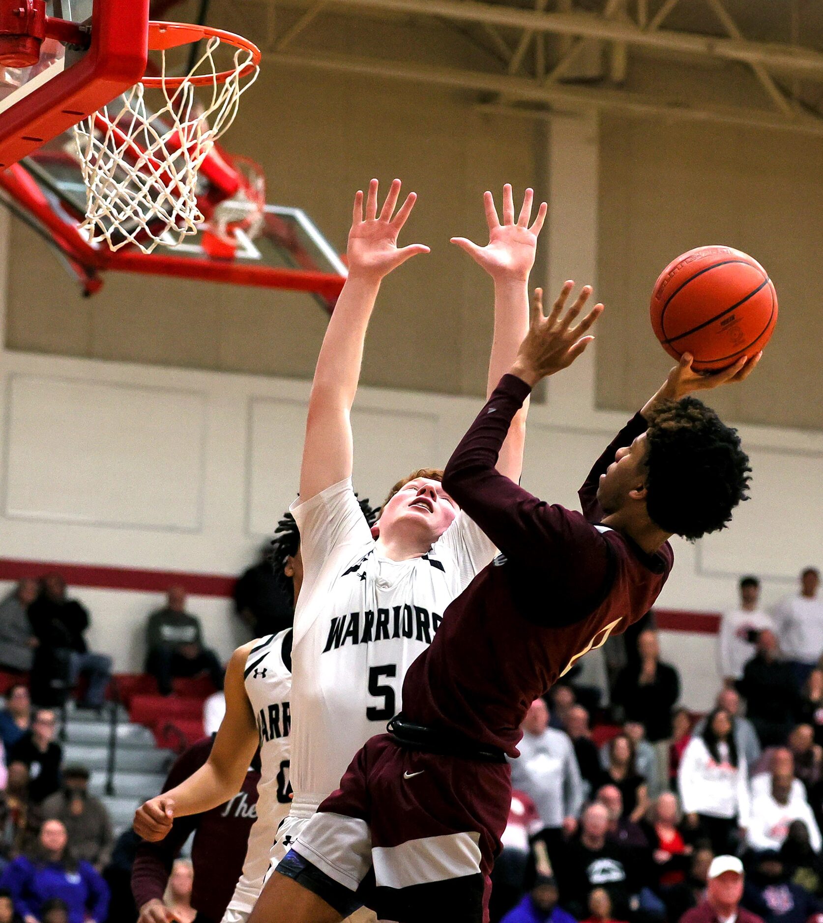 Lewisville guard Adrian Banks, (right) tries to get a shot off over Arlington Martin guard...