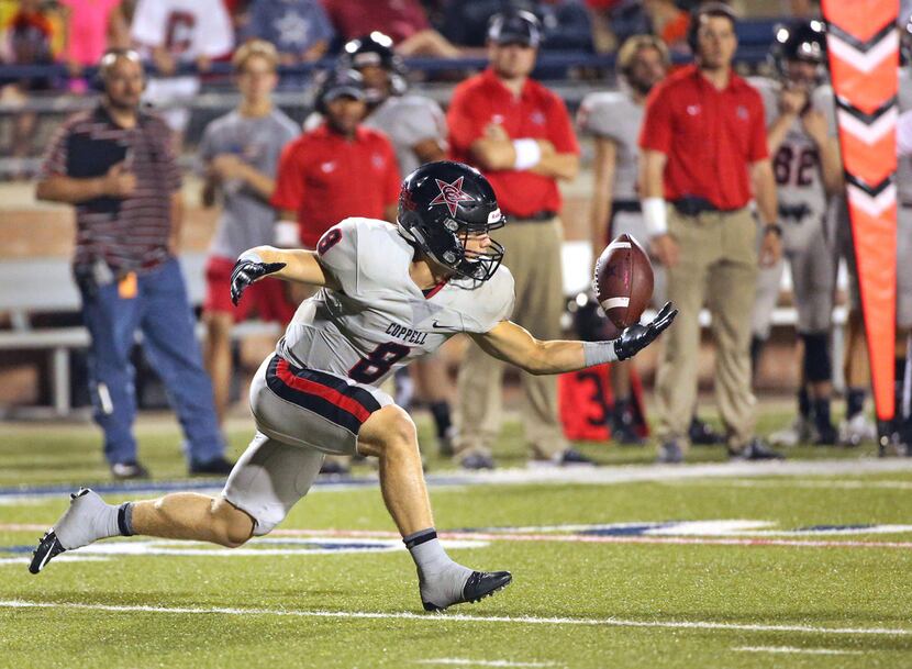 Coppell receiver Blake Jackson (8) keeps his eyes on the ball as he catches a second-quarter...