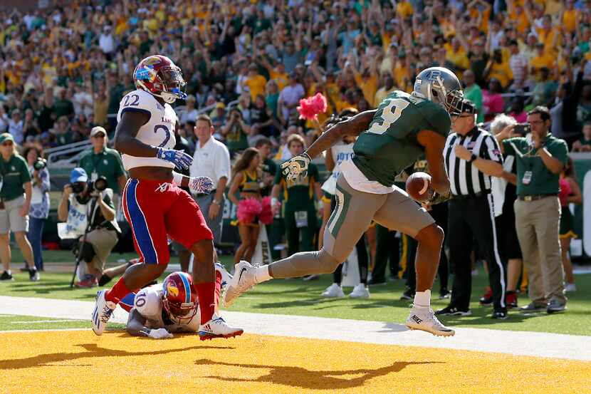 Baylor wide receiver KD Cannon (9) scores a touchdown past Kansas safety Greg Allen (22) and...