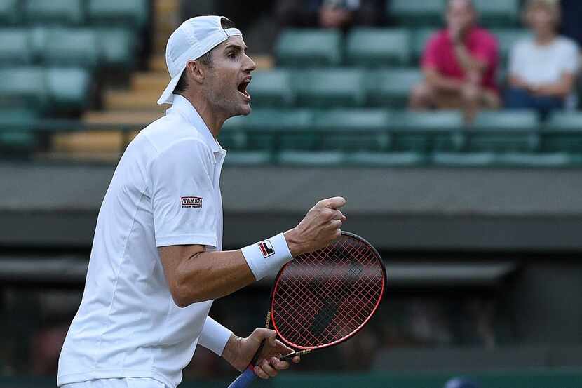 US player John Isner celebrates after beating Canada's Milos Raonic 6-7, 7-6, 6-4, 6-3 in...