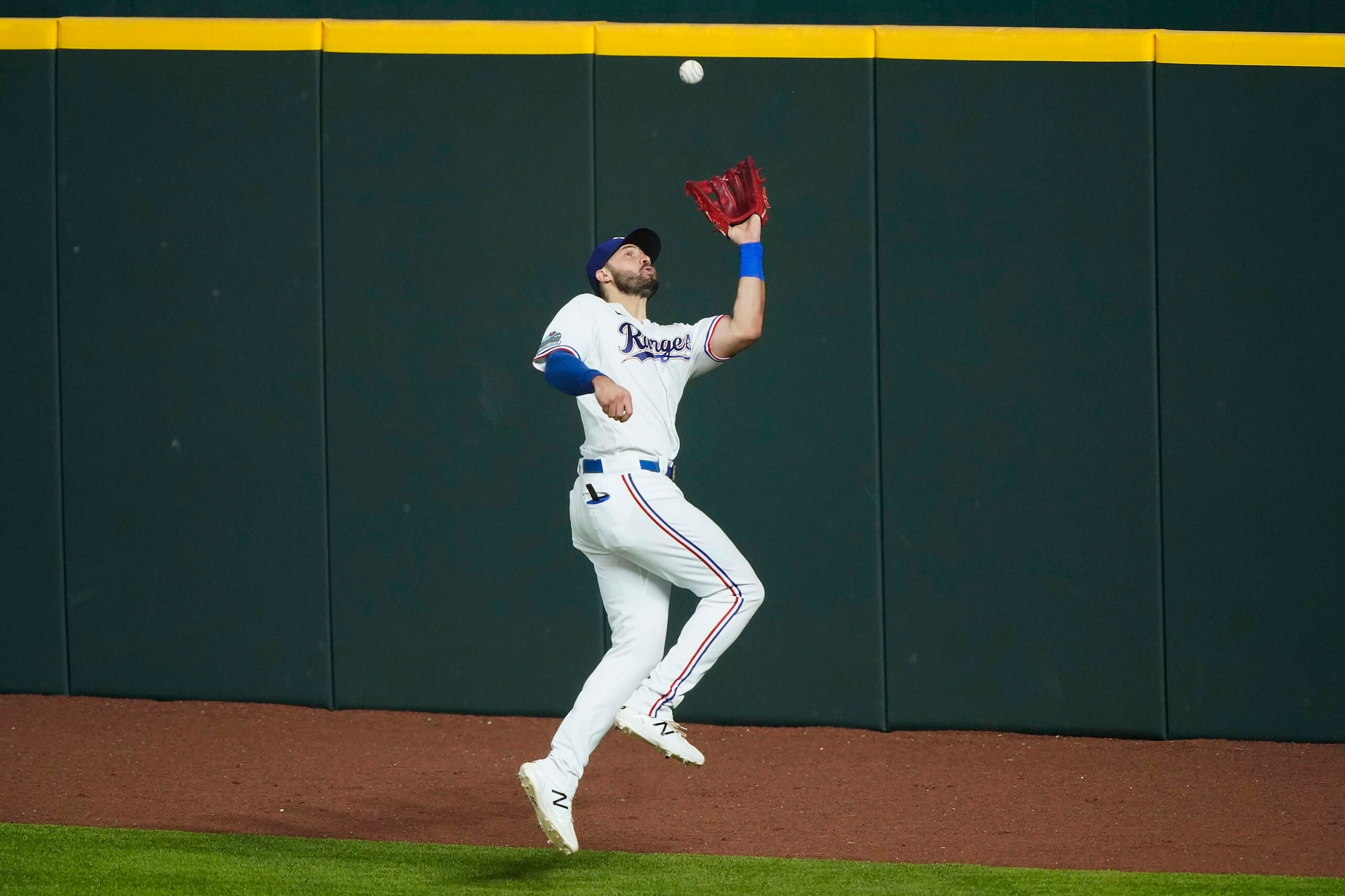 Outfielder Joey Gallo makes a leaping catch on the warning track on a fly ball off the bat...