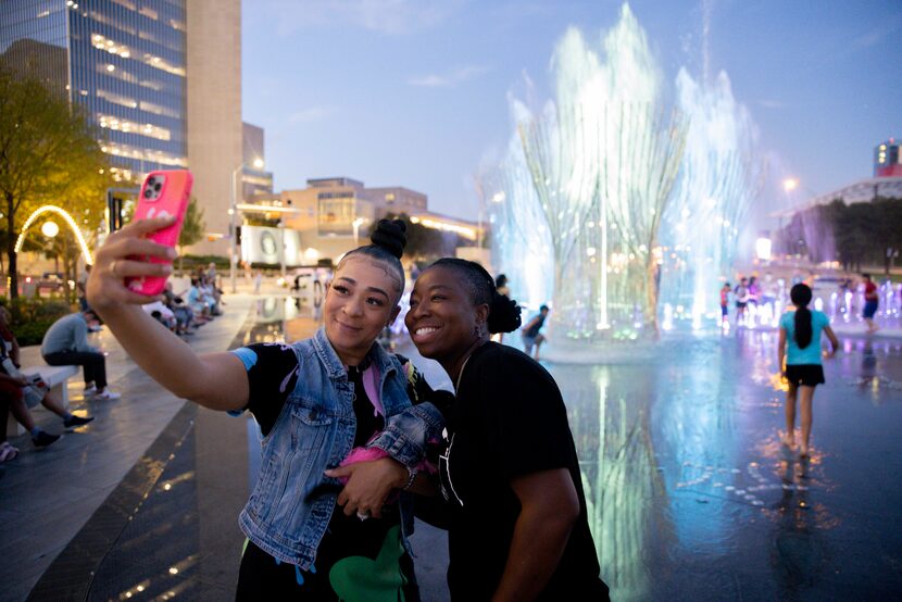 Tiffany Lewis (left) poses with wife Brenda Scott and their dog Zoe Scott during the...