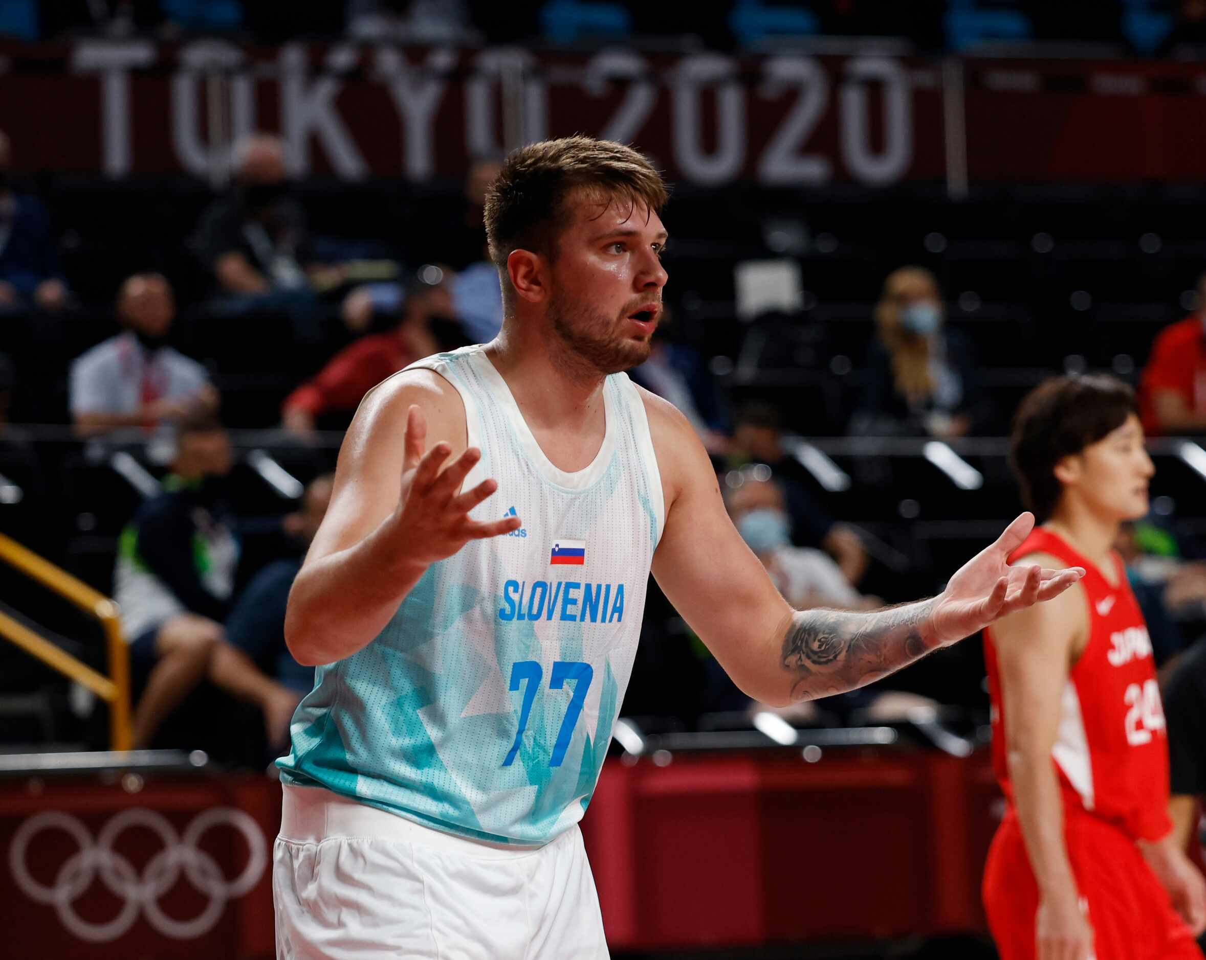 Slovenia’s Luka Doncic (77) questions a call in a basketball game against Japan during the...