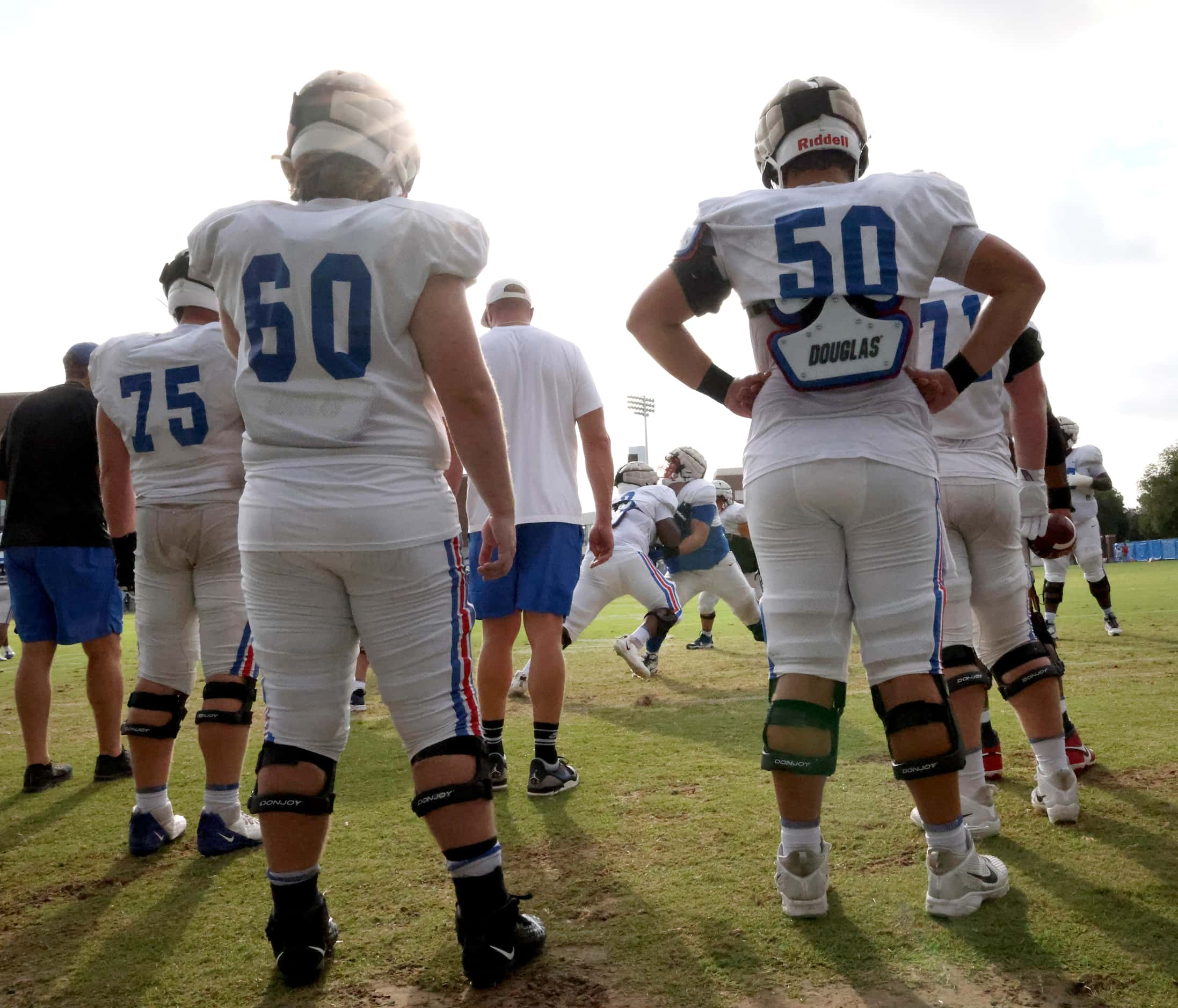 SMU offensive linemen work on a blocking drill. The Southern Methodist University Football...