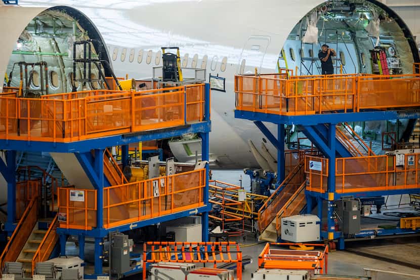 Boeing employees assemble 787s inside the plane maker's main assembly building in North...