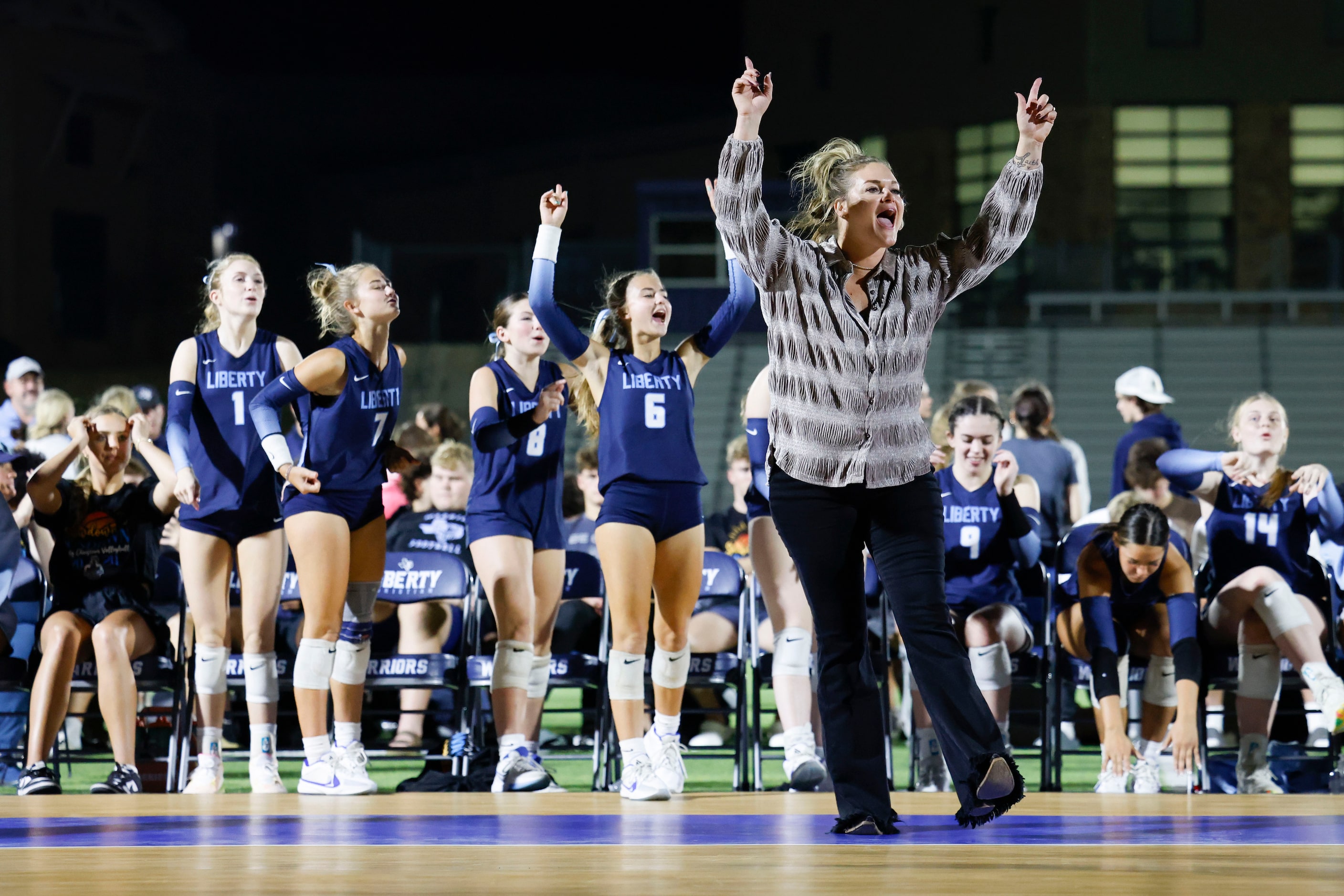 Liberty Christian School volleyball head coach Megan Degroot celebrates a point during an...