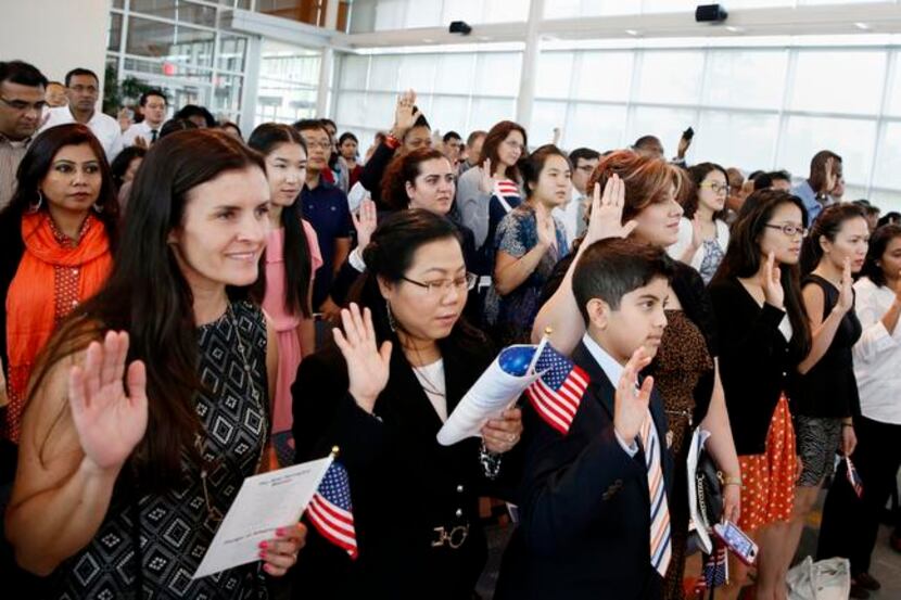 
New American citizens took the Oath of Allegiance at a naturalization ceremony this month...