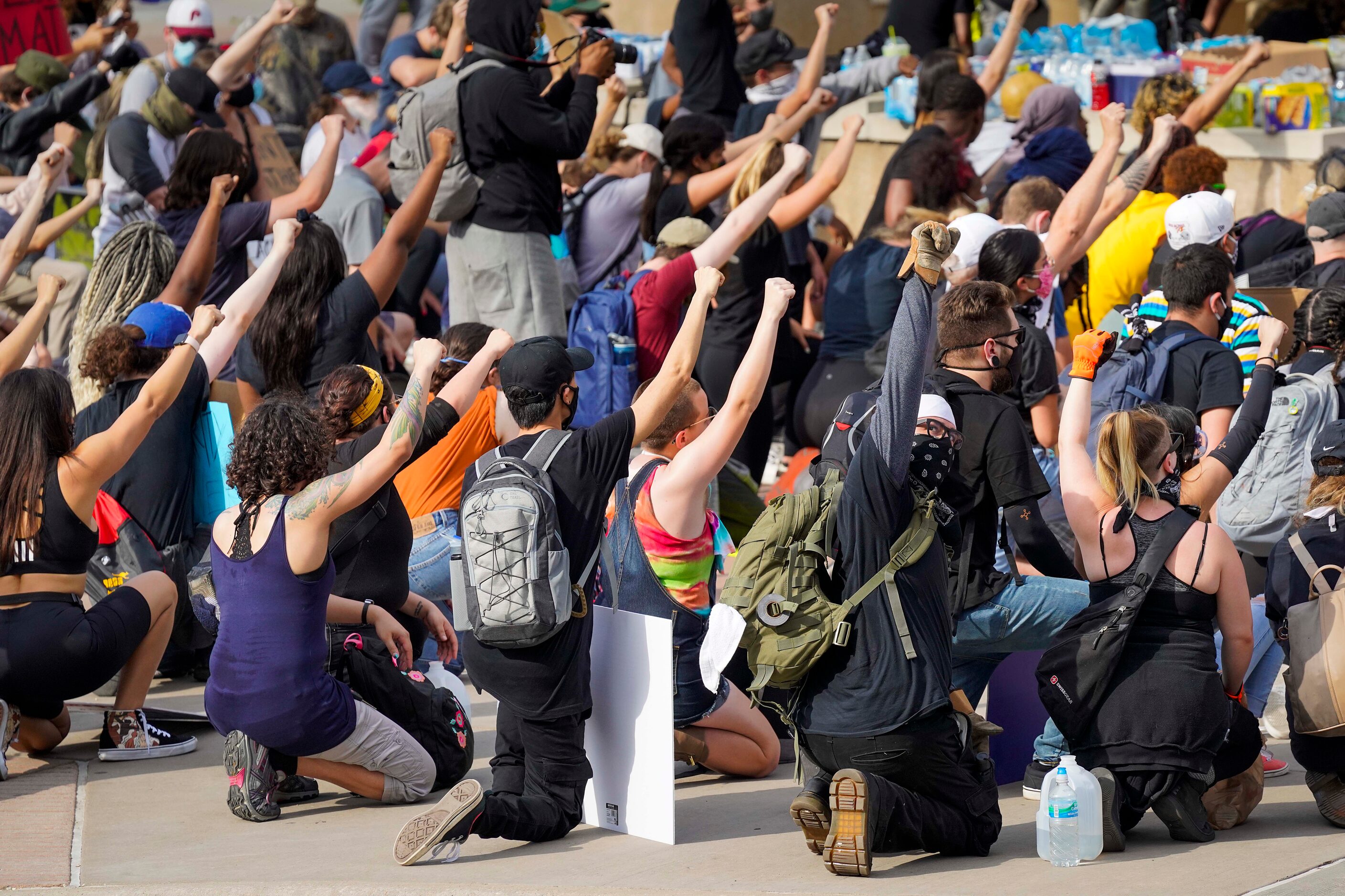 Demonstrators take a knee at Dallas Police Headquarters as protests continue after the death...