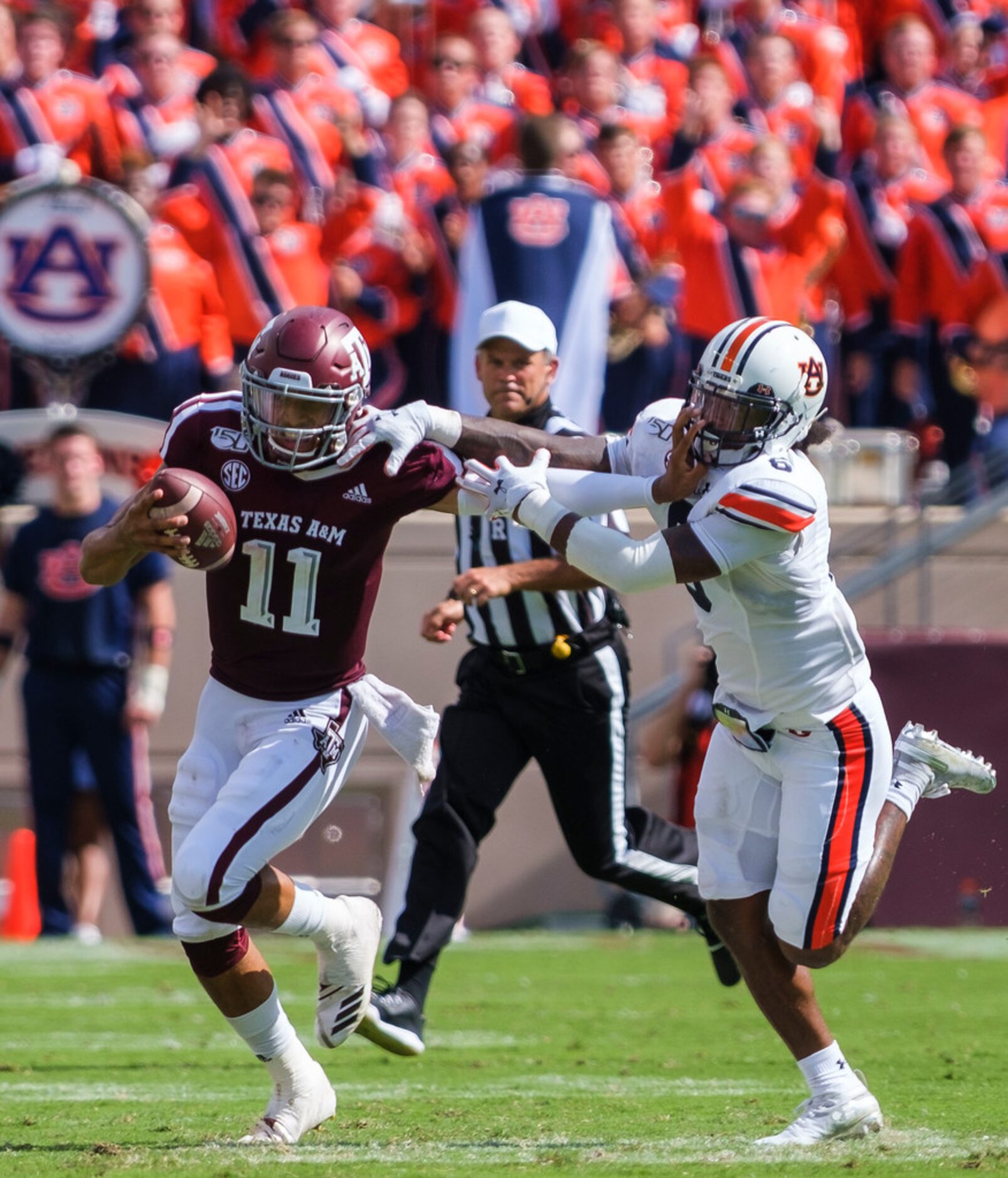 Texas A&M quarterback Kellen Mond (11) tries to fight off Auburn defensive back Christian...