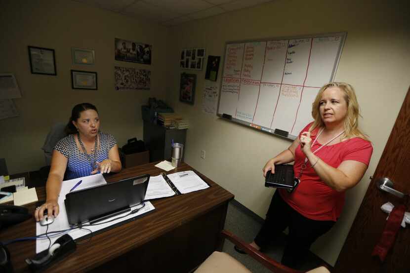 Tarrant County CPS child-abuse investigator Kelli Bailey (right) conferred with her...