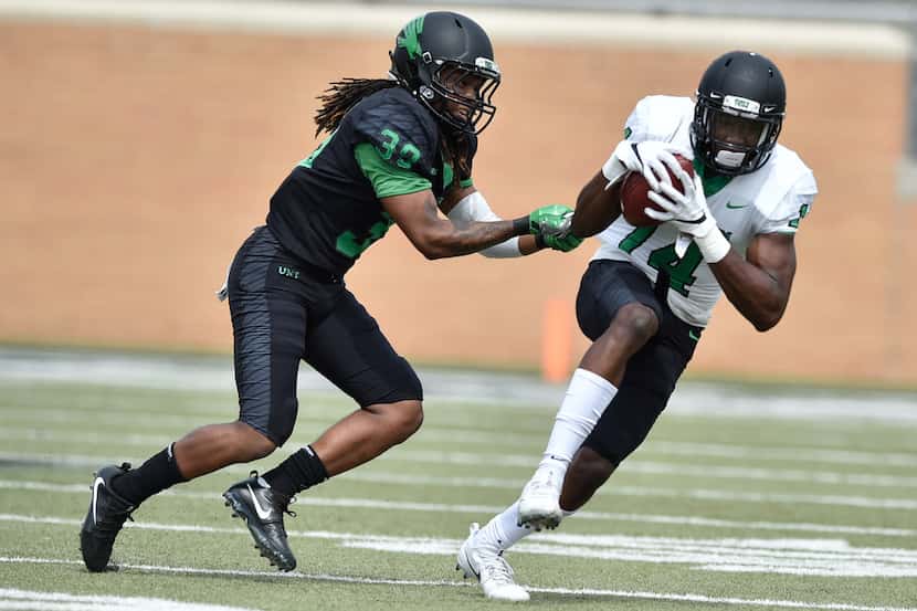 North Texas freshman wide receiver Greg White (14) catches a pass and is tackled by North...