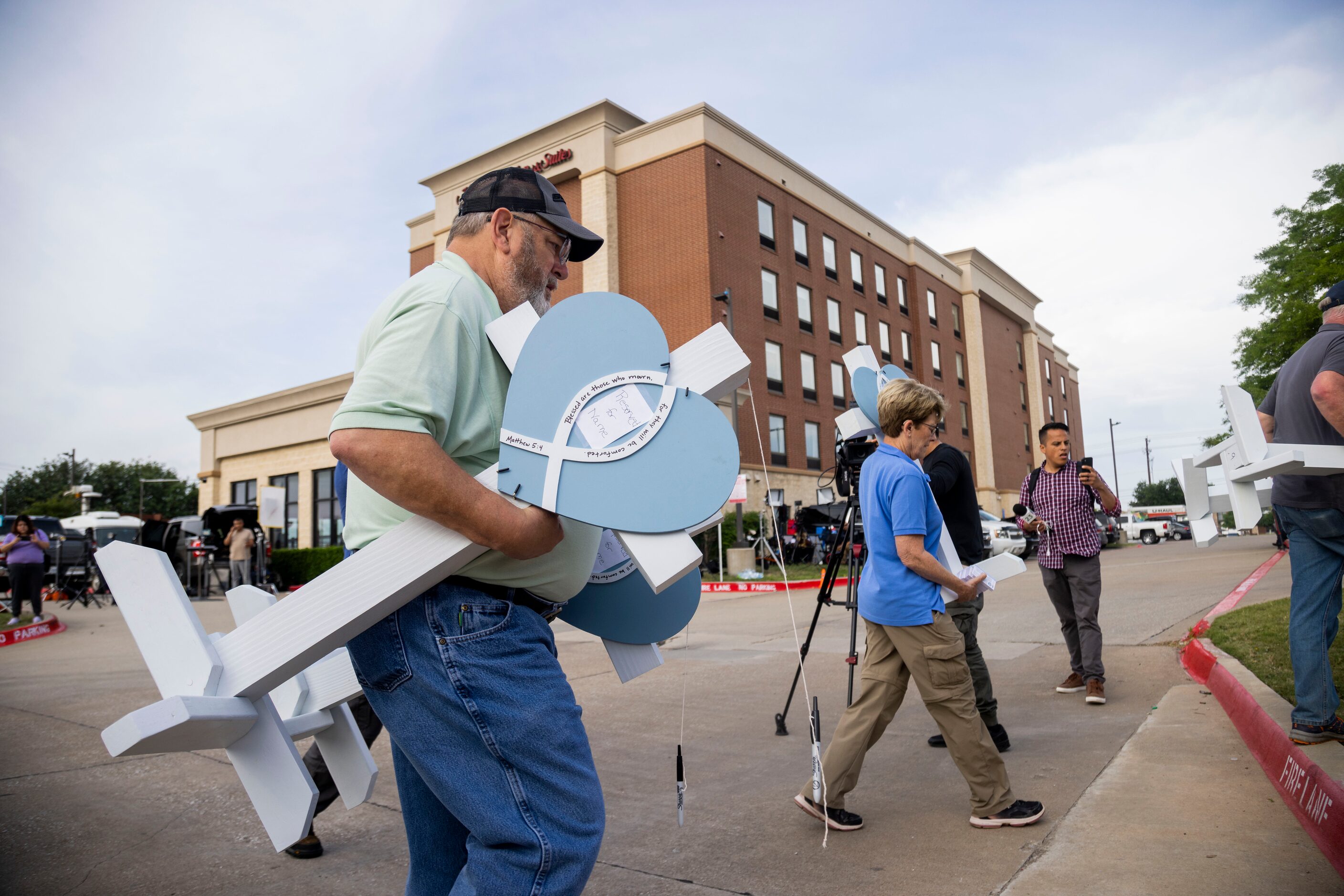 Phil Davis (left) of Fort Worth and other volunteers with Lutheran Church Charities carry...