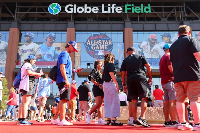 Fans make their way to the stadium ahead of the MLB All-Star baseball game, on Tuesday, July...