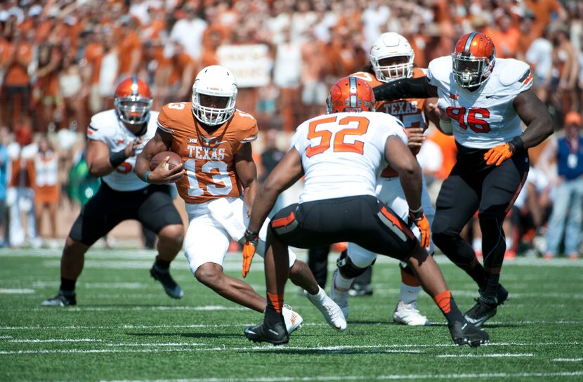 Longhorns quarterback Jerrod Heard (13) carries the ball against Oklahoma State. (Brendan...