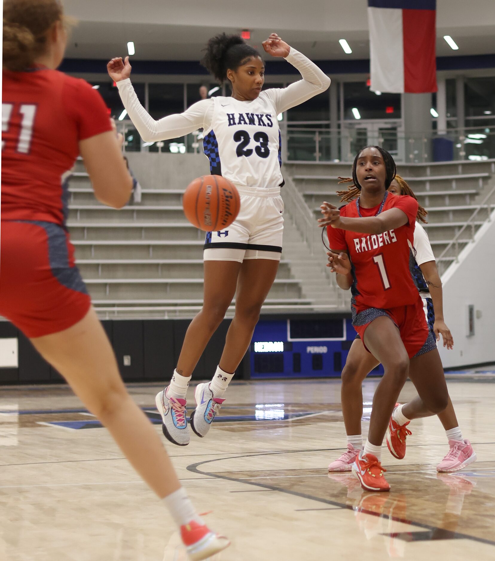 Denton Ryan guard Dashia Johnson (1), right, successfully passes to teammate Aspen Hicks...