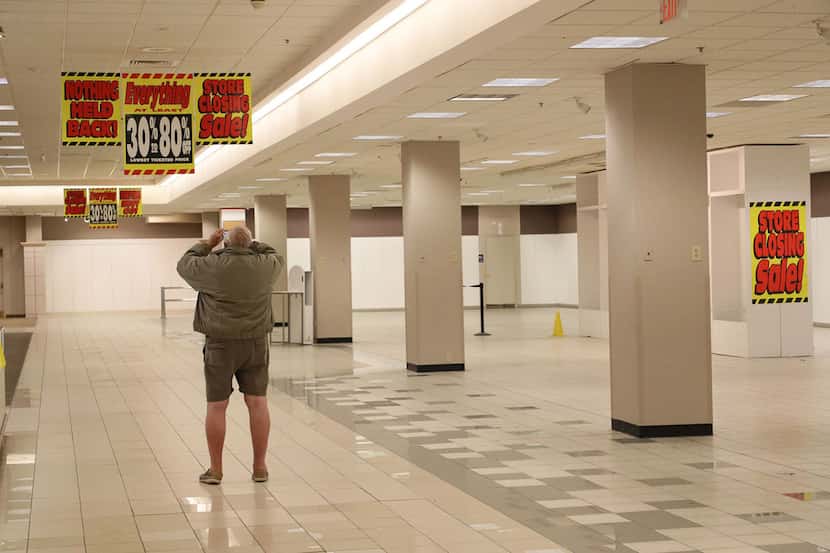 Gordon Beu takes photos inside Sears at Woodfield Mall on Nov. 11 before it permanently...