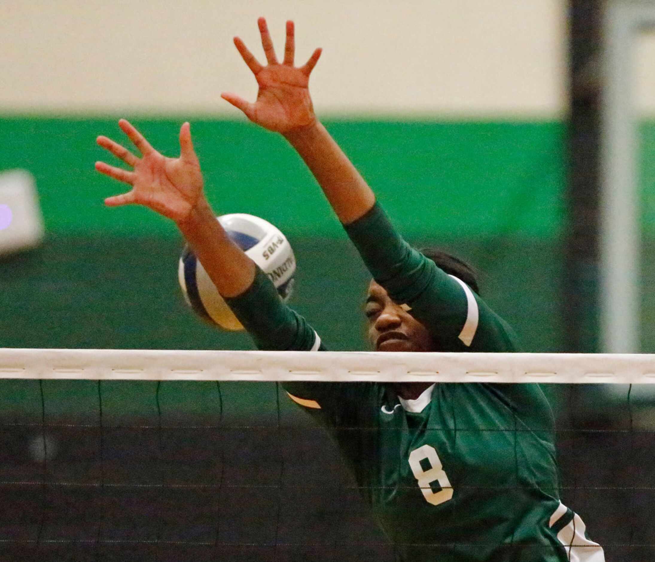 Lebanon Trail High School opposite Tyrah Ariail (8) attempts a block during game three as...