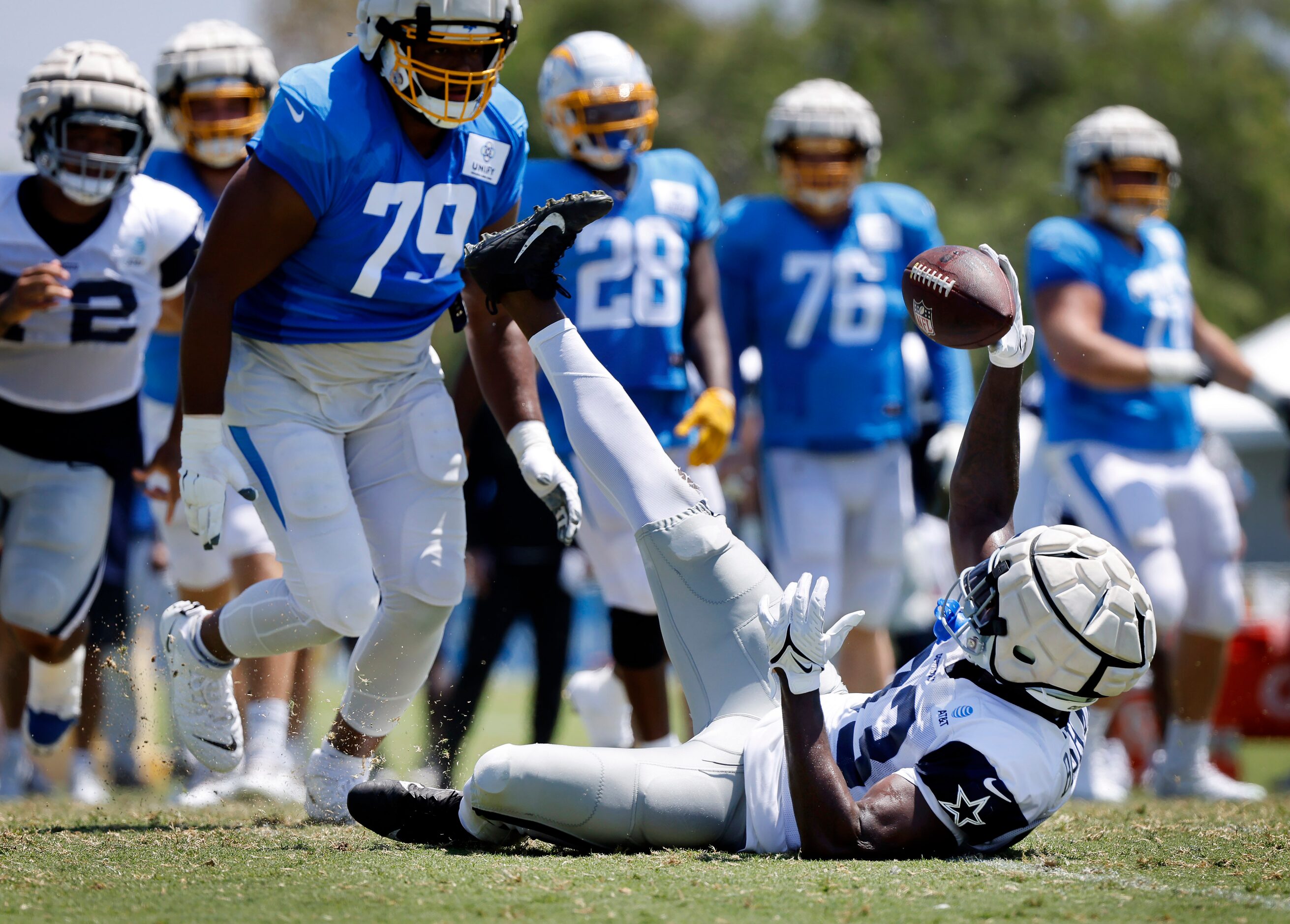 Dallas Cowboys defensive end Tarell Basham (93) makes an interception as he was falling the...