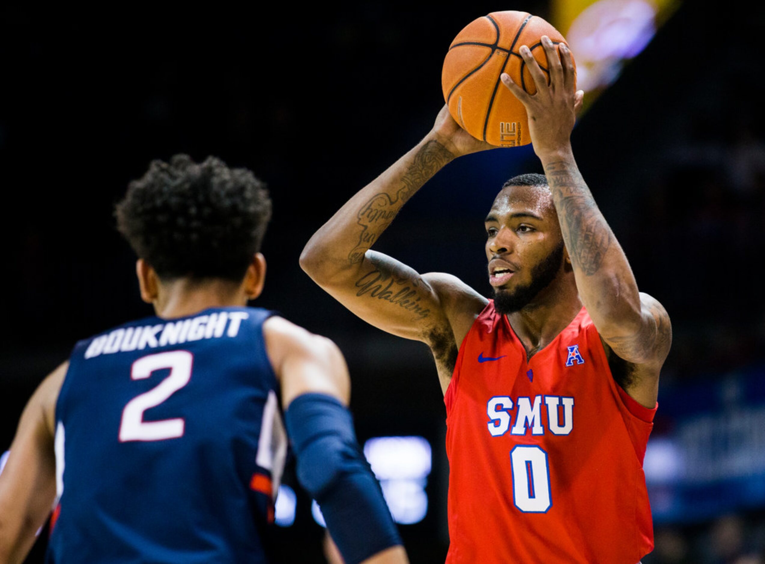 Southern Methodist Mustangs guard Tyson Jolly (0) looks for a pass over Connecticut Huskies...