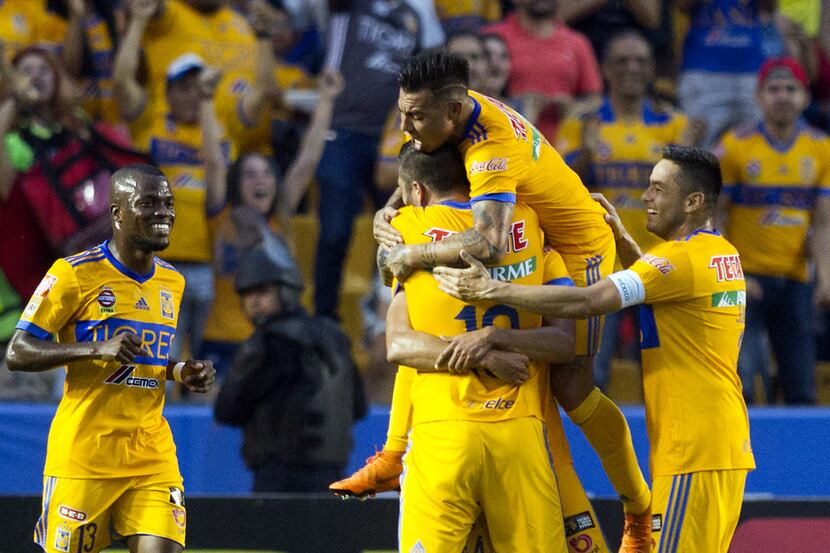 Tigres' players celebrate after scoring against Santos during the first leg of quarterfinal...