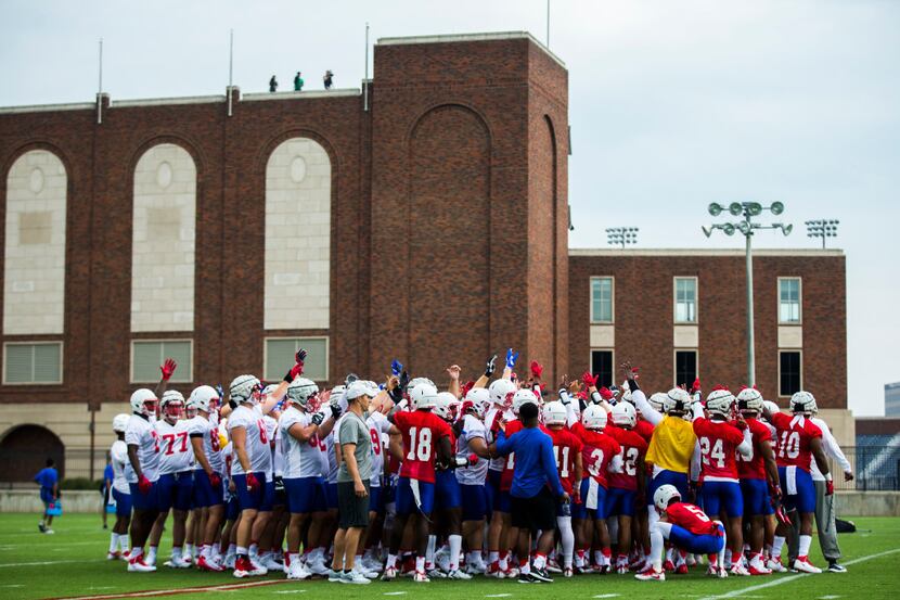 Football players huddle during SMU's first football practice of the season on Tuesday,...