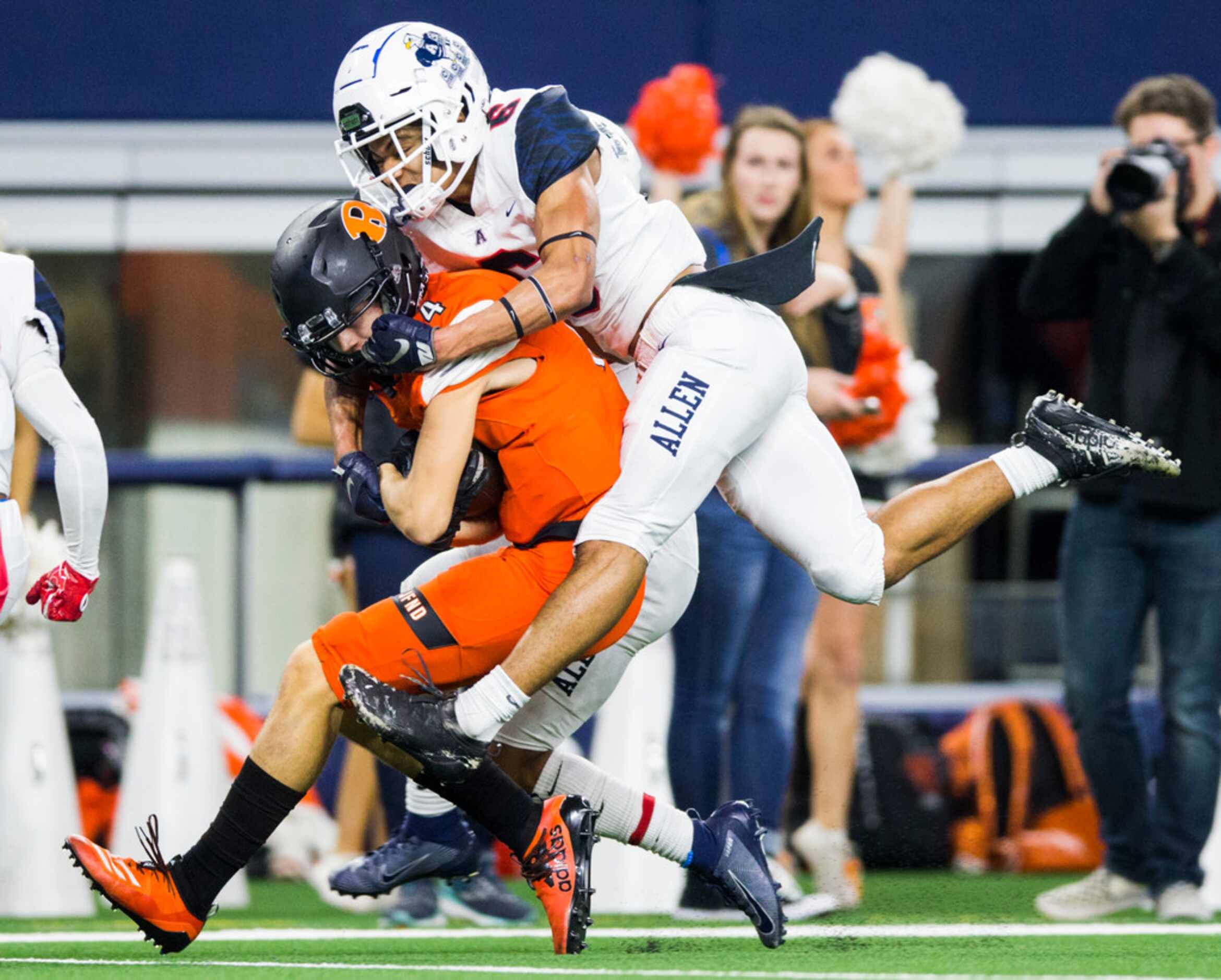 Rockwall's Cyvon Cezar (4) is tackled by Allen defensive back Matthew Norman (6) during the...