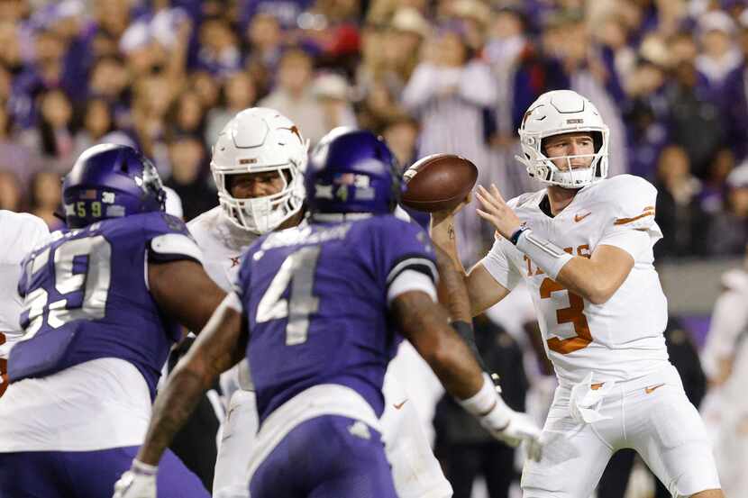 Texas Longhorns quarterback Quinn Ewers (3) passes under pressure from TCU Horned Frogs...