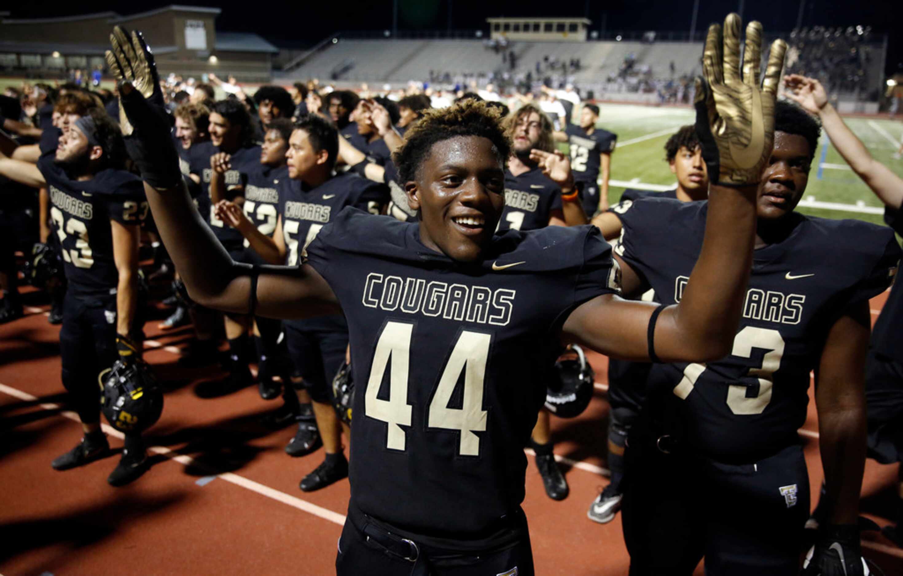 The Colony defensive end Kyair Warner (44) directs the band as they sing the school song...